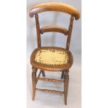 A 19thC beech child's high chair, with a bar back, a rattan woven seat on splayed legs, (seat AF)