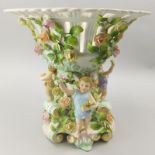 A Dresden porcelain centrepiece, the pierced bowl with encrusted decoration of flowers and leaves,