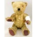 A sheepskin teddy bear, with leather pads, 54cm long