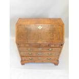 A small walnut bureau in mid 18thC style, the fall with a cross banded border enclosing a fitted