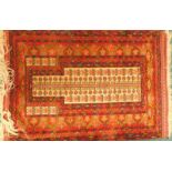 An Eastern patterned prayer rug, with an arrow design, on a red ground, 91cm x 125cm