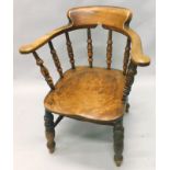 A 19thC captain's type chair, with spindle turned supports, turned legs, stamped to the reverse W.