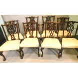 A set of eight mahogany dining chairs, in George III style, each with a pierced splat, a padded