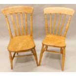 Two similar 19thC lathe back kitchen chairs, each with a solid seat, on turned legs