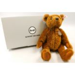 A Steiff collection teddy bear, with pendant containing five pfenning coin, boxed