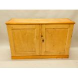 A pine side cabinet, with two panelled doors, on a plinth base, adapted, 131cm wide