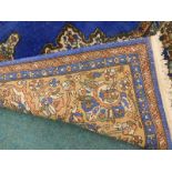 A large Persian style machine woven carpet, with a central pole medallion on a blue ground with