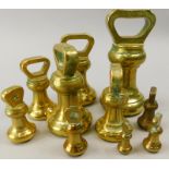 An associated set of brass bell weights, ranging from 4lb to 1oz