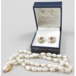 A pearl necklace and a pair of earrings, the single strand natural pearl necklace, with an oval