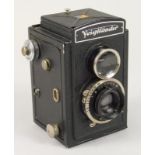 A Voigtlander Brilliant camera, with metal case, Compur shutter etc.