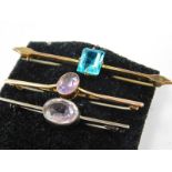 Three bar brooches, to include two yellow metal stone set bar brooches, and a silver purple stone