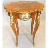 A late 19thC walnut occasional table, the circular shaped top with a gilt metal border, the frieze