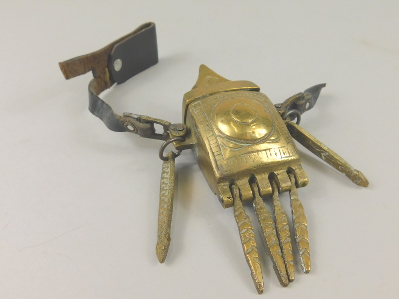 A Middle Eastern match container, with leather belt attachment and various striking mechanisms,