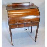 An Edwardian mahogany cylinder bureau, the top with a boxwood strung gallery and a moulded edge,