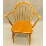 A light Ercol open arm stickback kitchen chair, the solid seat on turned legs with 'H' stretcher