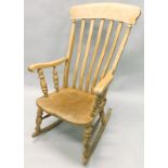 A 19thC beech and elm lathe open rocking arm chair, on turned supports