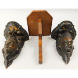 A pair of Continental carved oak wall brackets, each decorated with a figure with a winged helmet