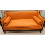 An early 19thC mahogany sofa, with a reeded frame, upholstered in patterned coral coloured fabric,
