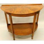 A mahogany two tier side table, with a frieze drawer above a galleried undertier and tapering