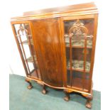 An early 20thC figured mahogany display cabinet, with a raised back above a bowed central door