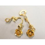 A pair of floral drop earrings, in rose design, gold plated, clip on, boxed.