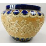 A Doulton stoneware jardiniere, decorated with rococo scrolls on a beige ground, within cobalt