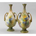A pair of Hadley's Worcester porcelain vases, each decorated with wild flowers, leaves etc., the