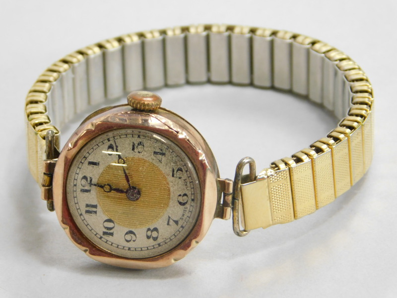 A wristwatch, with a 9ct gold wristwatch head, with gold and silvered coloured dial, and purple