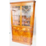 A George III mahogany standing corner cabinet, with a moulded cornice above two astragal glazed