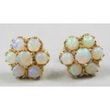 A pair of opal cluster earrings, each set with seven opals, in a claw setting, yellow metal,