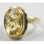 A 9ct gold dress ring, set with citrine stone, on pierced shoulders, 4.4g all in.