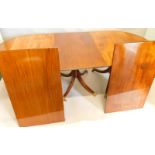 A mahogany extending dining table, in Regency style, the top with a reeded edge, supported by