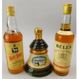 A bottle of Bells whisky, a White Horse whiskey bottle and a bottle of Bells 1989 winter 1895 Scotch