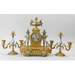 A French late 19thC gilt metal and porcelain clock garniture, the clock mounted with an urn above