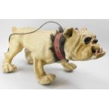 A late 19th/early 20thC French papier mache nodding bulldog figure, with leatherette and horse