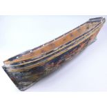 A late 19th/early 20thC pine model boat hull, with black painted decoration (AF), 101cm long