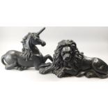 A pair of late 19th/early 20thC cast iron fire dogs, modelled in the form of a unicorn and a lion,