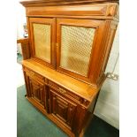 A Continental oak dresser, the top with a moulded cornice above two doors with brass grilles,