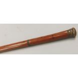 A malacca walking stick, the top with screw top revealing a recess with a glass file and stopper,