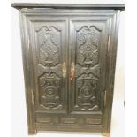 A 19thC Continental ebonised oak armoire, with a moulded cornice above two panelled doors, each
