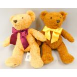 Two Steiff teddy bears, each wearing a bow