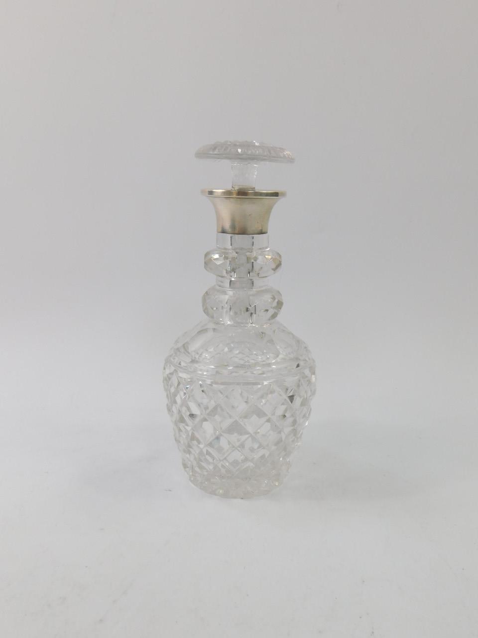 A Victorian cut glass two ring decanter, with mushroom shaped stopper and silver collar,