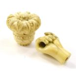 Two carved ivory parasol handles, one in the form of a hand, the other a crown, both 4cm long.