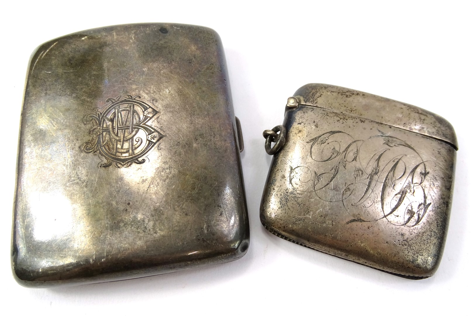 A large Edwardian silver vesta case, Birmingham 1904 and a cigarette case, bearing inscription for