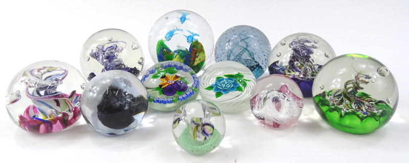 Various 20thC glass paperweights to include a swirl example set with blue and green flower, marked