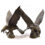 A pair of late 20thC/early 21stC gilt cast metal models of eagles, 62cm wide.
