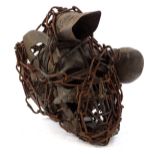 A West African type voodoo skull, with chain surround and orb side section, the main body 24cm