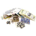 A large quantity of foreign coins, some stamps, postcards etc.