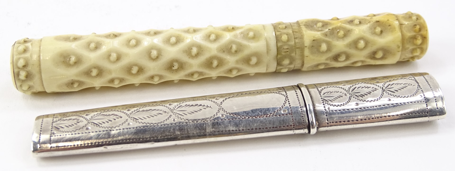 A late 19thC carved ivory needle case, of cylindrical outline, decorated with a repeat dot
