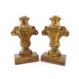 A pair of Continental giltwood candle holders, each of shaped scroll outline, carved with stylised